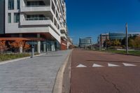 the city street is empty of cars and no people on the sidewalk or bikes on the side