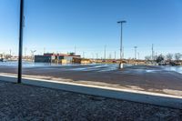 a view of a parking lot from outside a building on a sunny day the picture is taken from under