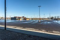 a view of a parking lot from outside a building on a sunny day the picture is taken from under