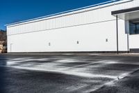 a parking lot that has been watered off with a carwash machine and jet power