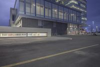 the parking lot in front of a glass building is empty and empty of cars parked outside