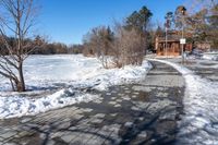 a path along a frozen lake that has been filled with snow to keep it from being screed