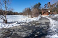 a path along a frozen lake that has been filled with snow to keep it from being screed