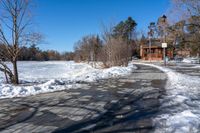 a path along a frozen lake that has been filled with snow to keep it from being screed