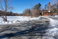 a path along a frozen lake that has been filled with snow to keep it from being screed