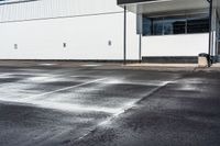 an empty parking lot is dotted with water from a faucet on the pavement