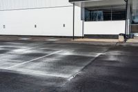 an empty parking lot is dotted with water from a faucet on the pavement