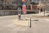 a red traffic meter sits at the corner in an urban setting near buildings and trees