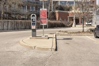 a red traffic meter sits at the corner in an urban setting near buildings and trees