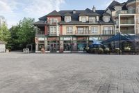 an old - fashioned square building with outdoor seating on it, and tables set up in the middle of it