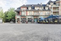 an old - fashioned square building with outdoor seating on it, and tables set up in the middle of it