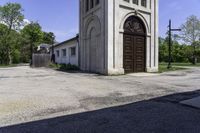 an old church in the middle of the street is empty but there are no people around