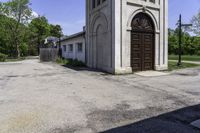 an old church in the middle of the street is empty but there are no people around