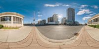 a 360 view of a street with buildings in the background and a sun in the sky