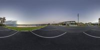 a fisheye panoramic shot of a residential neighborhood in canada with an ocean and boat