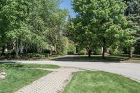 a small car drives down a deserted street in the park at daytime in this urban area