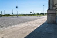 the road has many empty traffic lanes along it, and the street in the middle is empty with a few vehicles in the distance