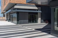 a building with a black and white pattern flooring on it's side is empty