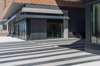 a building with a black and white pattern flooring on it's side is empty