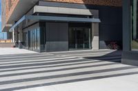 a building with a black and white pattern flooring on it's side is empty