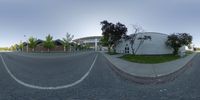 a fish eye view of a road with buildings around it in the background to represent an image about moving forward