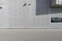 a skateboarder riding past a building with an antenna on it's side