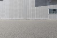 a skateboarder riding past a building with an antenna on it's side