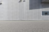 a skateboarder riding past a building with an antenna on it's side