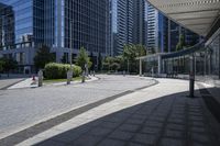 a person sitting at the bench in front of a mall that is empty of people