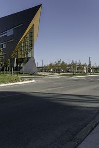 a traffic light with a building in the background and an arrow sign for a school