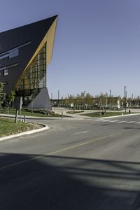 a traffic light with a building in the background and an arrow sign for a school