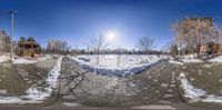 a 360 - shot of a snowy area next to a streetlight with some trees