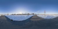 snow is piled up over two piles and on a road that has snow on it