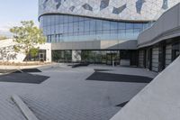 a view of an outside area of an office building with large windows and a circular driveway