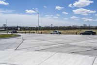 a street corner with a car and an suv on it next to a fenced off parking