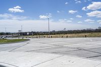 a street corner with a car and an suv on it next to a fenced off parking