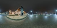 a fish eye view of the city with cars driving on the road at night near the parking lot