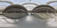 a curved structure of concrete in an empty building that has several arches and curved ceilings