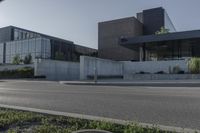 the two buildings have many windows and are next to a parking lot with parking meters