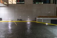 empty parking space with yellow stripes and a black car in the middle of the floor