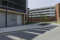 the empty street next to a building has a yellow stop sign on it with no parking