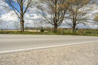 a person standing on a curb with a skateboard by the side of the road