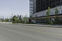 an empty street with a lot of parking and cars on the side of the road