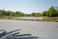 the parking lot with the water behind it is empty and there are no people around