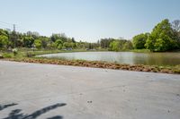 the parking lot with the water behind it is empty and there are no people around