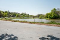 the parking lot with the water behind it is empty and there are no people around