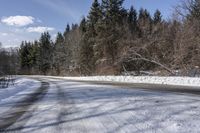 a road with no cars and some snow on the sides of it that is a large amount of snow