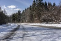 a road with no cars and some snow on the sides of it that is a large amount of snow