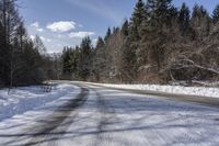 a road with no cars and some snow on the sides of it that is a large amount of snow