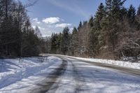 a road with no cars and some snow on the sides of it that is a large amount of snow